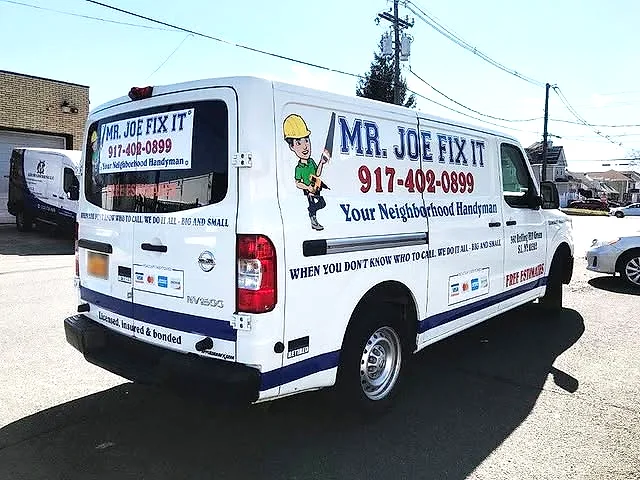 White Nissan NV cargo van with Mr. Joe Fix It handyman branding, mascot and phone number