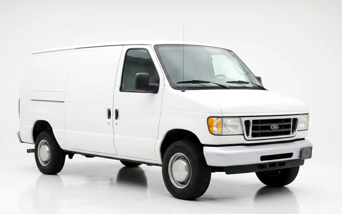 A plain white van being wrapped with the Applied Graphics design