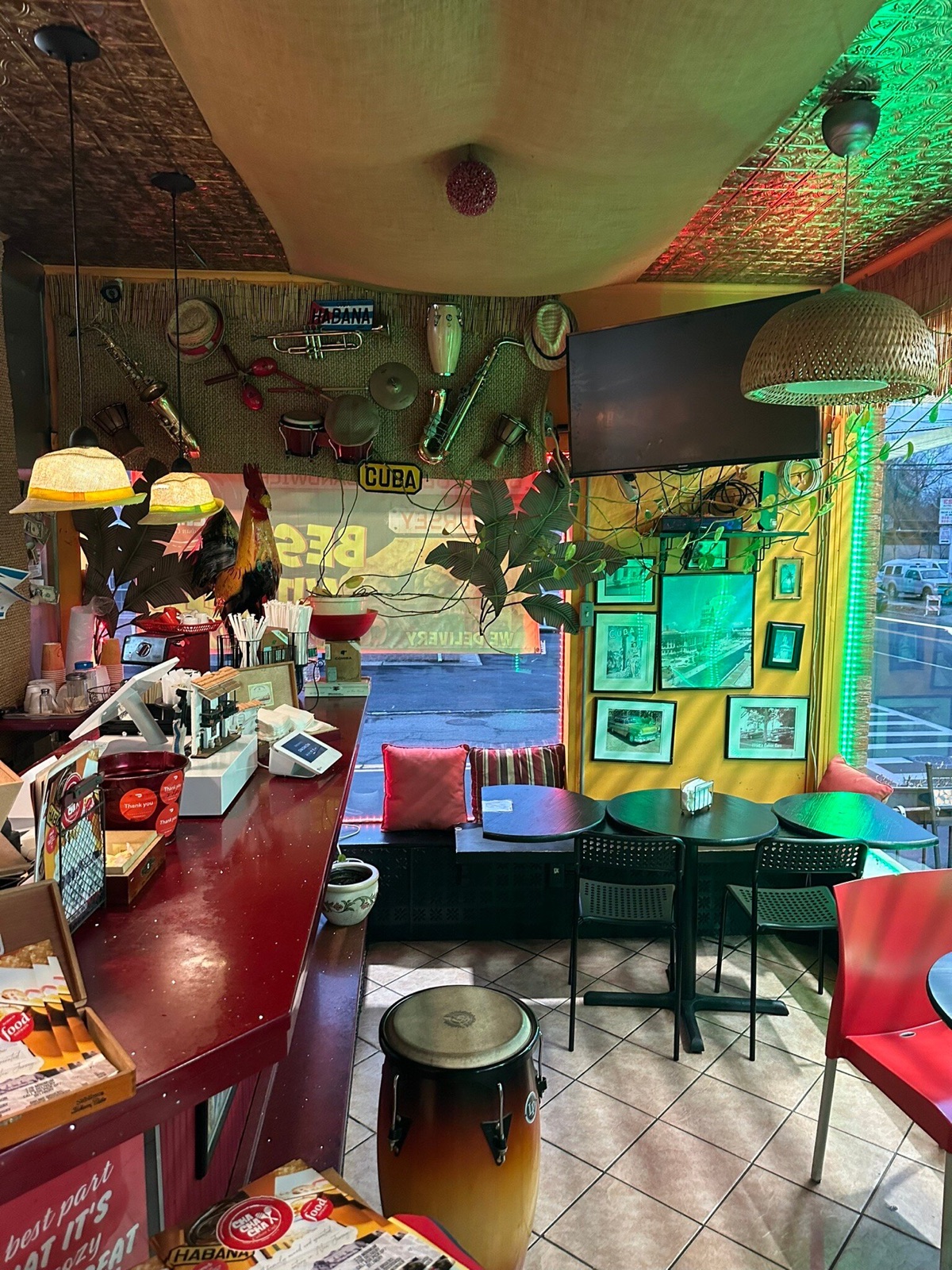 Inside Cha Cha Cha Cuban Cafe — warm Cuban decor, drum stools, vintage Havana photos
